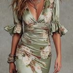 Anna - Asymmetrical long dress in green satin with V-neck, flared puff sleeves, and floral pattern